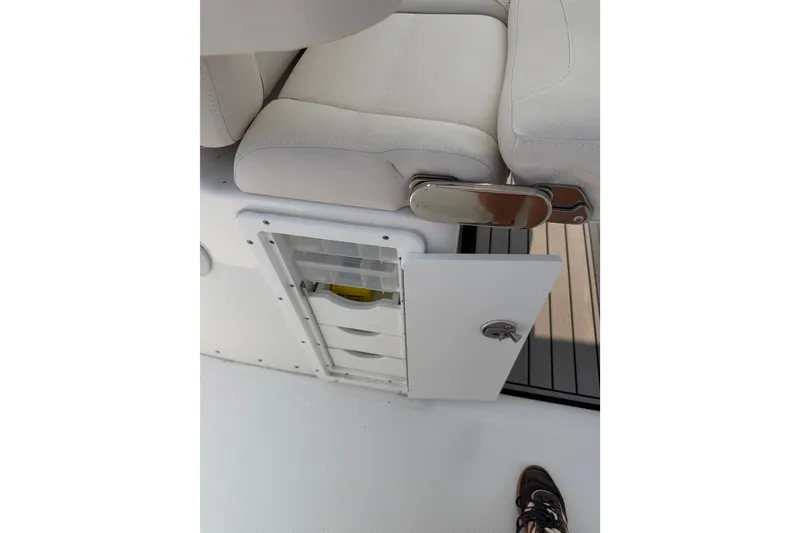 Slide: The Image of 2024 Sea Hunt Ultra 275 SE boat seat with open storage compartment. - 36