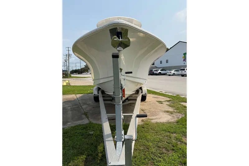 Slide: The Image of 2024 Sea Hunt Ultra 275 SE boat on trailer, front view in outdoor setting. - 14