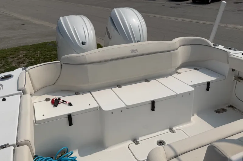 Slide: The Image of 2024 Sea Hunt Ultra 275 SE boat interior with dual engines and seating area. - 25