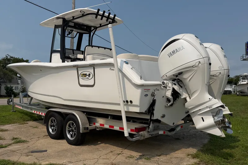 Slide: The Image of 2024 Sea Hunt Ultra 275 SE boat on trailer with twin Yamaha engines. - 1