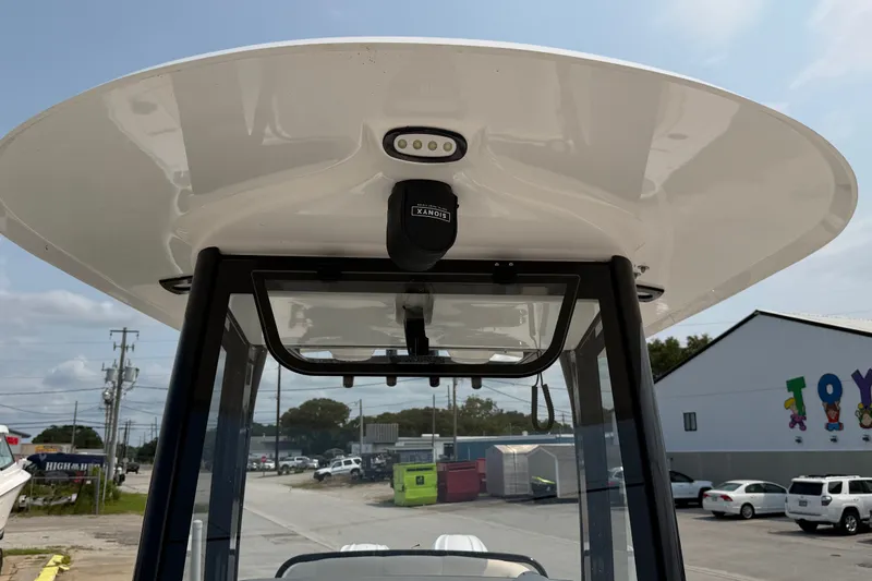 Slide: The Image of 2024 Sea Hunt Ultra 275 SE boat console with radar and light, outdoor setting. - 28