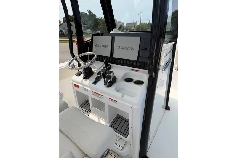 Slide: The Image of 2024 Sea Hunt Ultra 275 SE boat console with Garmin displays and steering wheel. - 37