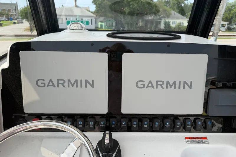 Slide: The Image of Dashboard of 2024 Sea Hunt Ultra 275 SE with dual Garmin displays. - 39
