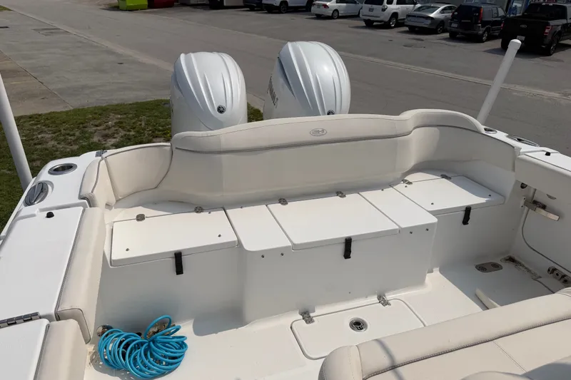 Slide: The Image of 2024 Sea Hunt Ultra 275 SE boat interior with dual engines and seating area. - 43