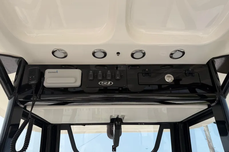 Slide: The Image of 2024 Sea Hunt Ultra 275 SE dashboard with Garmin equipment and control panel. - 42
