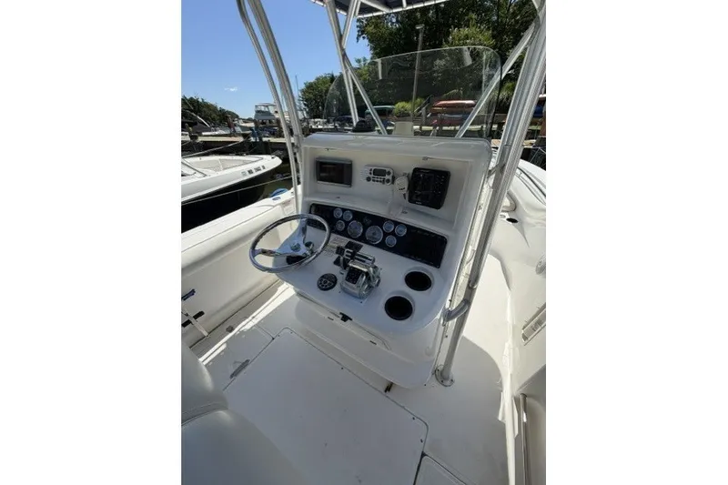 Slide: The Image of 2004 Boston Whaler 270 Outrage boat console with steering wheel and gauges. - 11