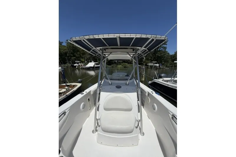 Slide: The Image of 2004 Boston Whaler 270 Outrage boat with T-top, docked on a sunny day. - 6