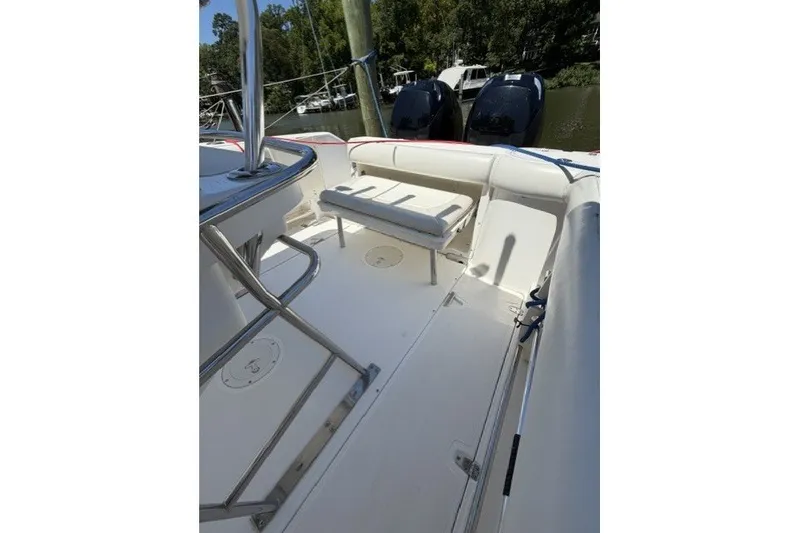 Slide: The Image of 2004 Boston Whaler 270 Outrage boat interior with seating and dual engines. - 13