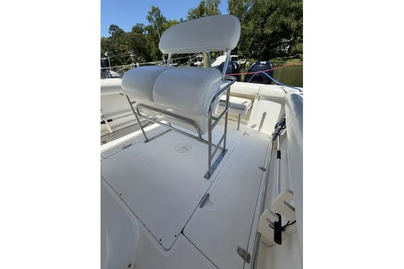 Slide: The Image of 2004 Boston Whaler 270 Outrage boat interior with white seating and spacious deck. - 7