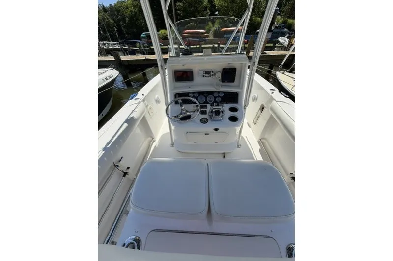 Slide: The Image of 2004 Boston Whaler 270 Outrage boat cockpit with steering wheel and control panel. - 10