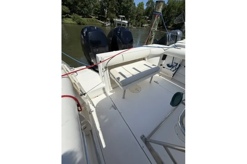 Slide: The Image of 2004 Boston Whaler 270 Outrage boat interior with seating and dual engines. - 14