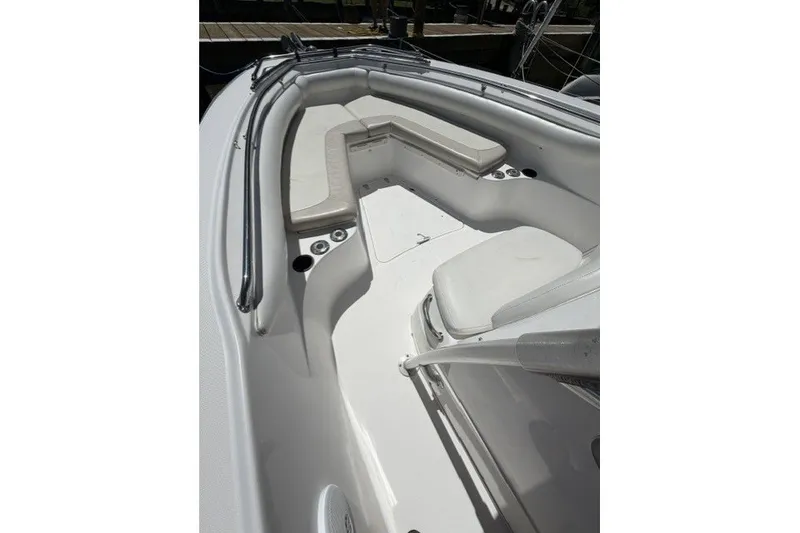 Slide: The Image of 2004 Boston Whaler 270 Outrage boat interior with cushioned seating and railings. - 4