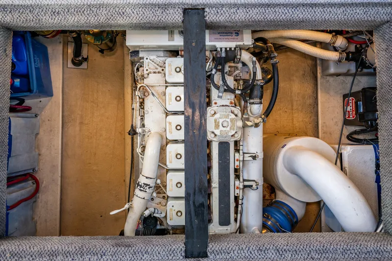Slide: The Image of Engine compartment of a 2000 Nordic Tug 32, showcasing mechanical components and piping. - 38