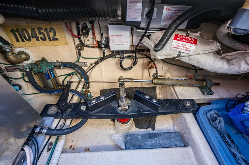 Slide: The Image of Engine compartment of a 2000 Nordic Tug 32, showcasing mechanical components and wiring. - 39