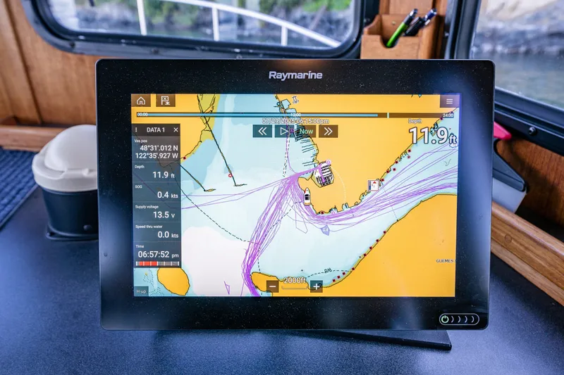Slide: The Image of Raymarine navigation display on 2000 Nordic Tug 32, showing nautical chart and vessel data. - 30