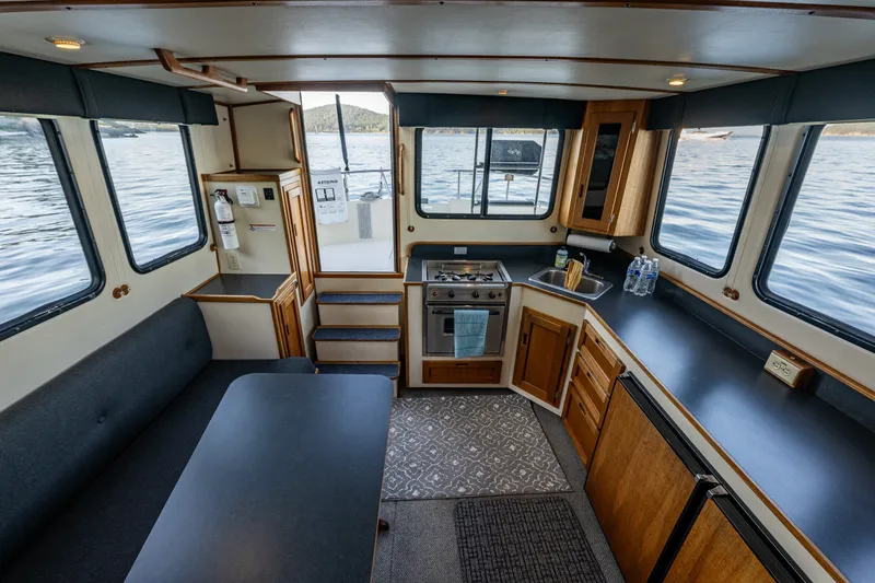 Slide: The Image of Interior of a 2000 Nordic Tug 32 boat with kitchen and dining area. - 25