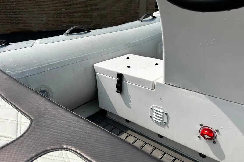 Slide: The Image of Interior of a 2021 Highfield Sport 330 boat, featuring seating and storage compartment. - 16