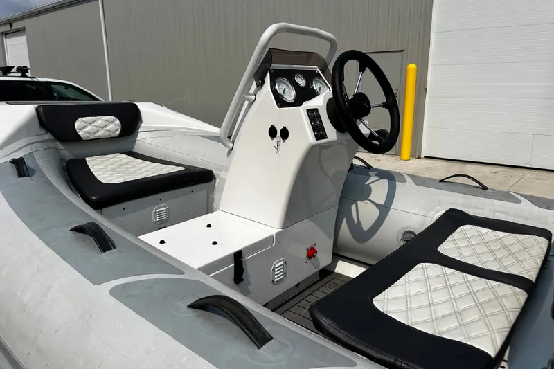 Slide: The Image of 2021 Highfield Sport 330 boat interior with steering console and cushioned seating. - 17