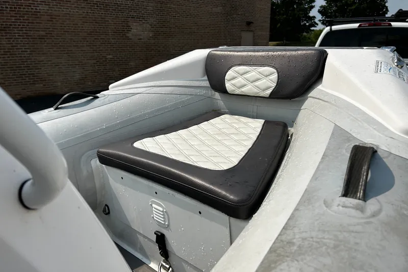 Slide: The Image of 2021 Highfield Sport 330 boat interior with cushioned seating, wet from recent use. - 11