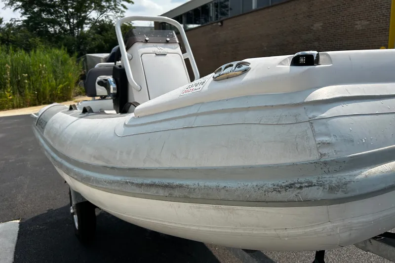 Slide: The Image of 2021 Highfield Sport 330 inflatable boat parked outdoors on a sunny day. - 15