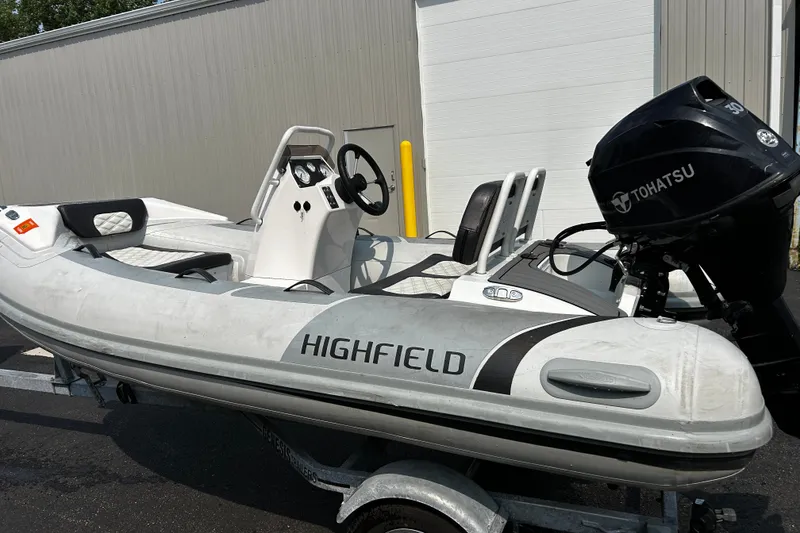 Slide: The Image of 2021 Highfield Sport 330 inflatable boat with Tohatsu outboard motor on a trailer. - 3
