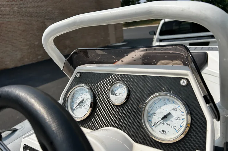 Slide: The Image of Dashboard of a 2021 Highfield Sport 330 boat with gauges and steering wheel. - 9