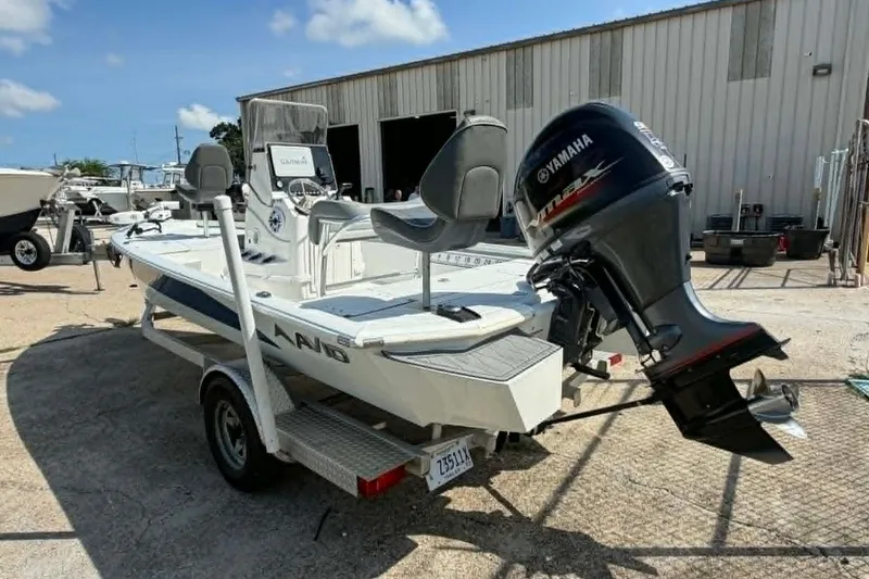 Slide: The Image of 2021 Avid 19 FS boat with Yamaha outboard motor on a trailer, parked outdoors. - 6
