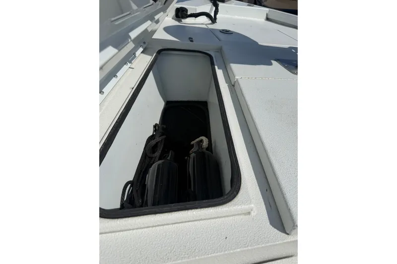 Slide: The Image of Storage compartment of 2021 Avid 19 FS boat, featuring ropes and equipment. - 11