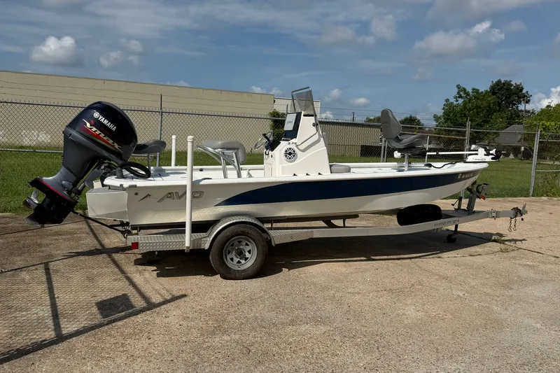 Slide: The Image of A 2021 Avid 19 FS boat on a trailer, featuring a Yamaha outboard motor. - 14