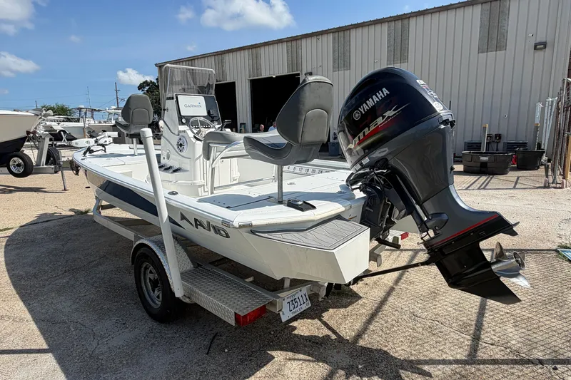 Slide: The Image of 2021 Avid 19 FS boat with Yamaha outboard motor on a trailer, parked outdoors. - 13