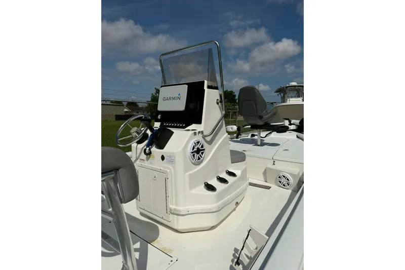 Slide: The Image of 2021 Avid 19 FS boat console with Garmin navigation system under clear blue sky. - 8