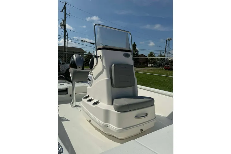 Slide: The Image of 2021 Avid 19 FS boat console with seating, outdoors under clear sky. - 7