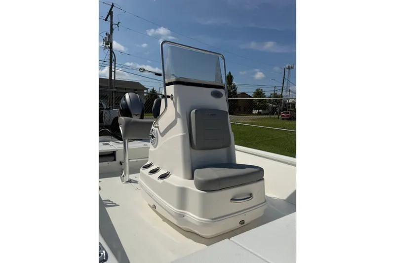 Slide: The Image of 2021 Avid 19 FS boat console with seating, outdoors under clear sky. - 6
