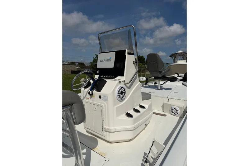 Slide: The Image of 2021 Avid 19 FS boat console with Garmin navigation system under clear blue sky. - 7
