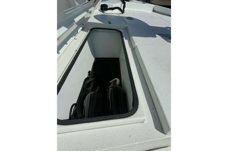 Slide: The Image of Storage compartment of 2021 Avid 19 FS boat, featuring organized equipment storage. - 11
