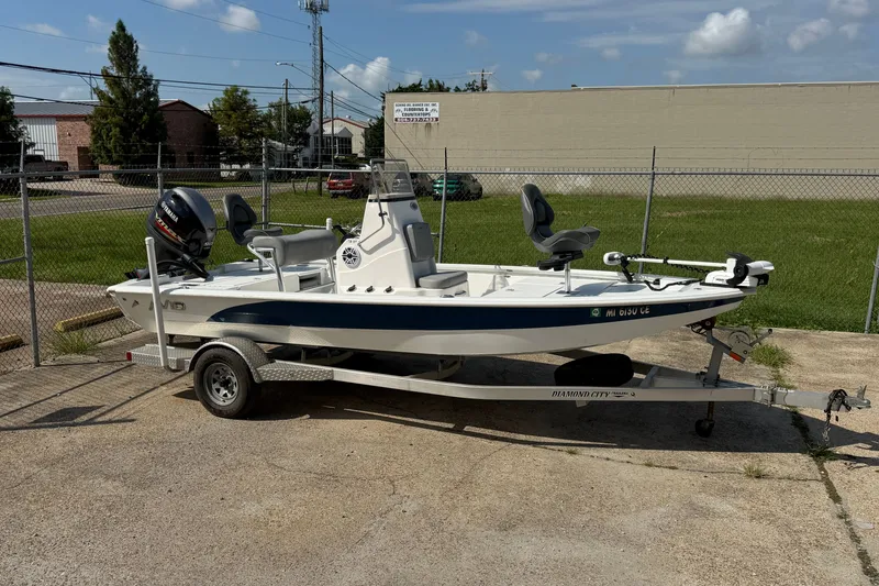 The Image of 2021 Avid 19 FS boat on trailer, parked outdoors, featuring Yamaha outboard motor. - 0