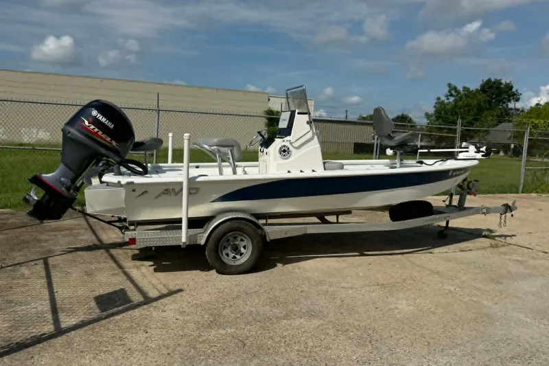 Slide: The Image of 2021 Avid 19 FS boat with Yamaha engine on trailer, parked outdoors. - 4