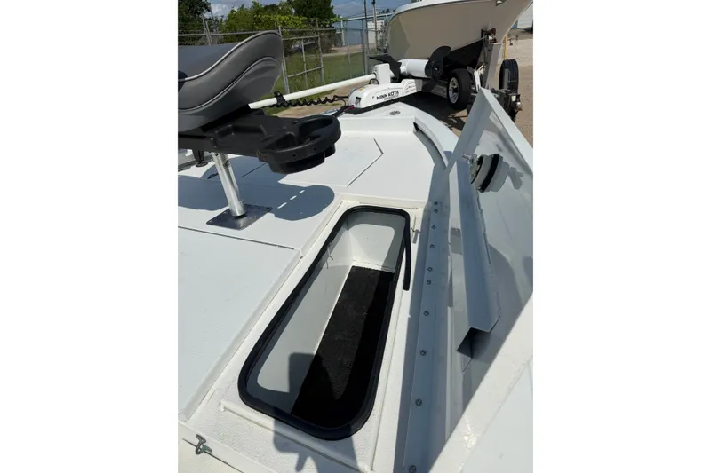 Slide: The Image of 2021 Avid 19 FS boat deck with storage compartment and seating. - 12