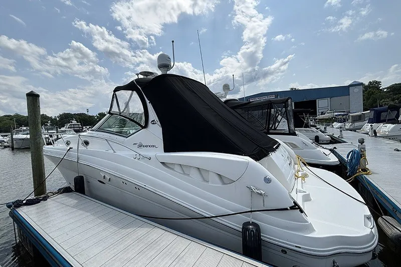 The Image of 2006 Sea Ray 340 Sundancer docked at marina under partly cloudy sky. - 3