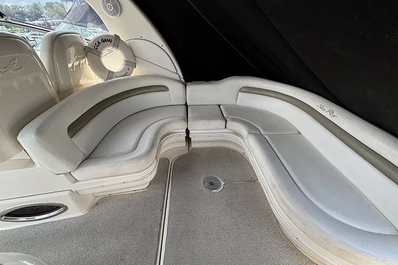 Slide: The Image of Interior seating of 2006 Sea Ray 340 Sundancer boat, featuring curved white upholstery. - 6