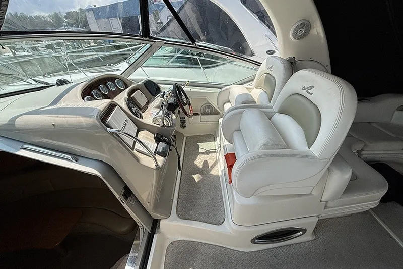 Slide: The Image of 2006 Sea Ray 340 Sundancer cockpit with white leather seats and modern dashboard controls. - 13