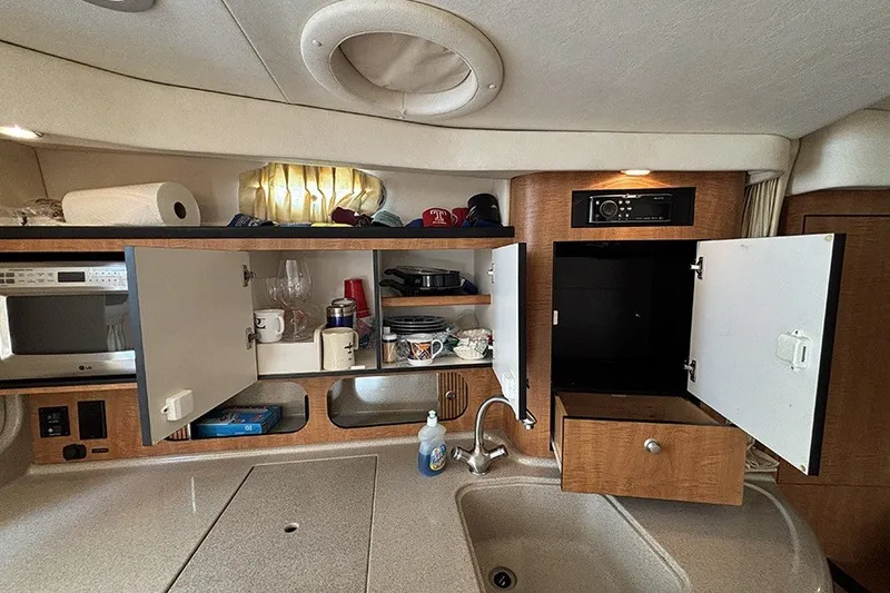 Slide: The Image of Interior of 2006 Sea Ray 340 Sundancer showing kitchen cabinets and sink area. - 25