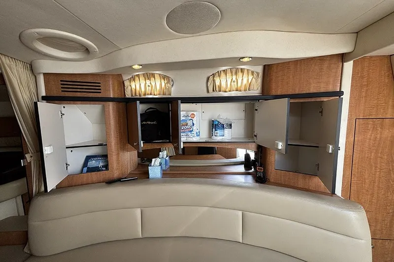 Slide: The Image of Interior of a 2006 Sea Ray 340 Sundancer yacht with open cabinets and seating area. - 30