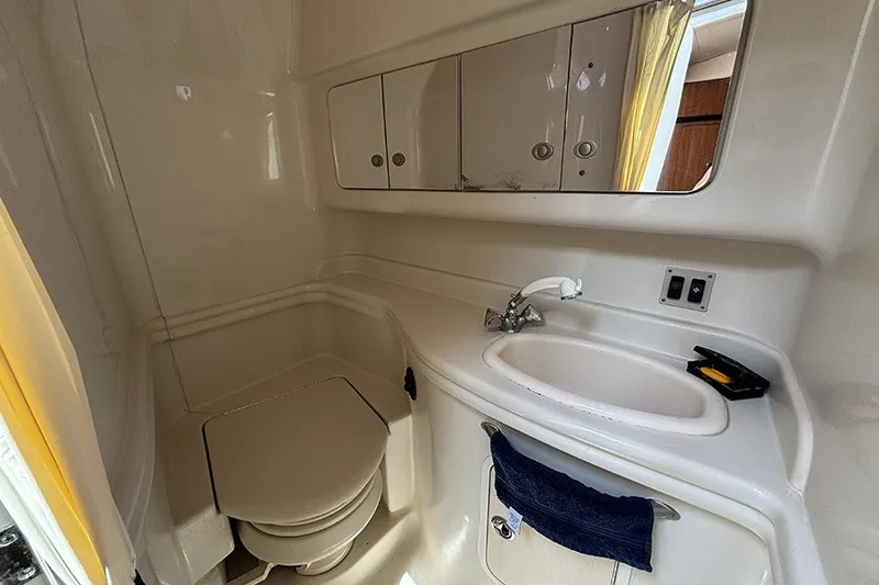 Slide: The Image of 2006 Sea Ray 340 Sundancer bathroom with sink, mirror, and storage cabinets. - 33