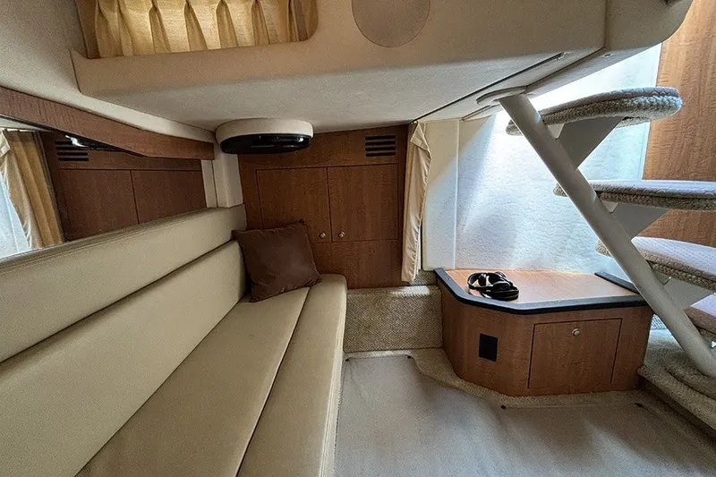 Slide: The Image of Interior of 2006 Sea Ray 340 Sundancer yacht with beige seating and wooden cabinetry. - 36