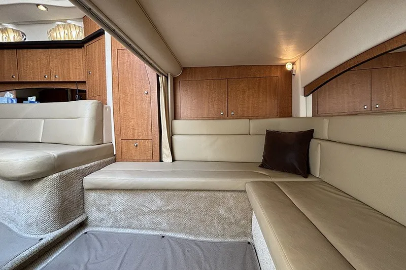 Slide: The Image of Interior of 2006 Sea Ray 340 Sundancer yacht with beige seating and wooden cabinetry. - 35