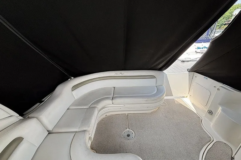 Slide: The Image of 2006 Sea Ray 340 Sundancer interior with curved seating and black canopy. - 7