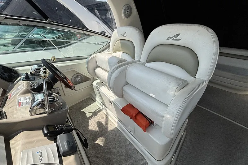 Slide: The Image of 2006 Sea Ray 340 Sundancer cockpit with dual helm seats and steering wheel. - 14