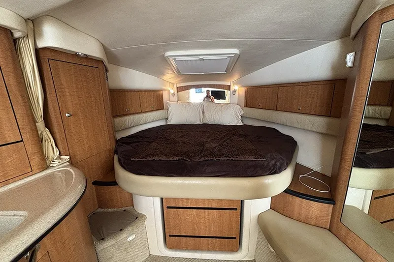 Slide: The Image of Interior cabin of 2006 Sea Ray 340 Sundancer yacht with cozy bed and wooden cabinetry. - 21