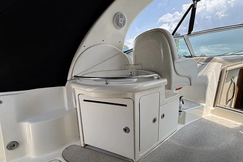 Slide: The Image of 2006 Sea Ray 340 Sundancer interior with seating and compact kitchenette. - 9
